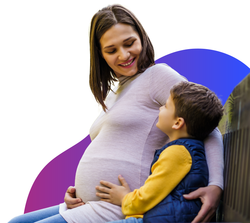 Pregnant Mom Sitting on Bench with Son Pregnant Mom Sitting on Bench with Son